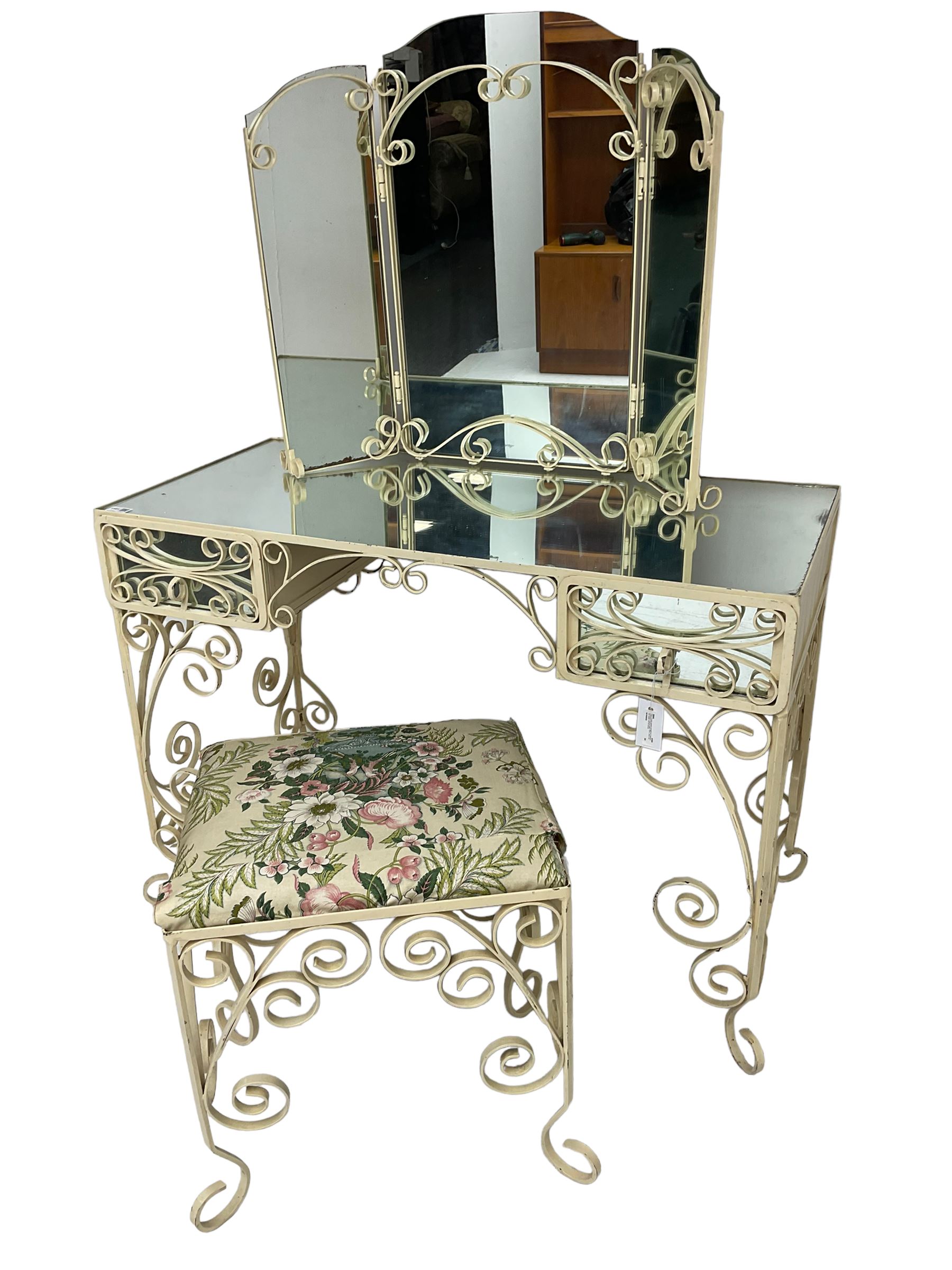 Cream painted scroll work wrought metal dressing table, fitted with two drawers and mirror top, together with matching triple mirror and stool