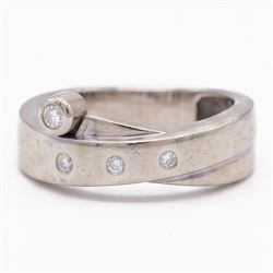 14ct white gold four stone diamond crossover ring, rubover and bezel set with four round c...