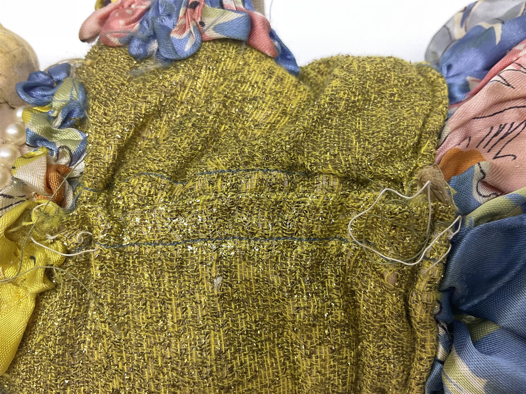 Victorian large wax over composition Pumpkin head doll, with inset dark glass eyes, moulded blonde hair in curls, stuffed body with carved and painted wooden limbs, grey painted boots, floral satin dress with netting underclothes H61cm