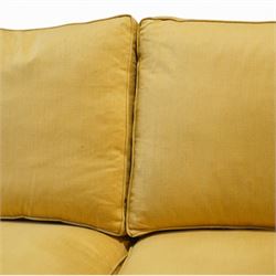 Pair of mid-20th century traditional two seat sofas, loose cushioned seat and back upholstered in pale gold fabric, on turned supports