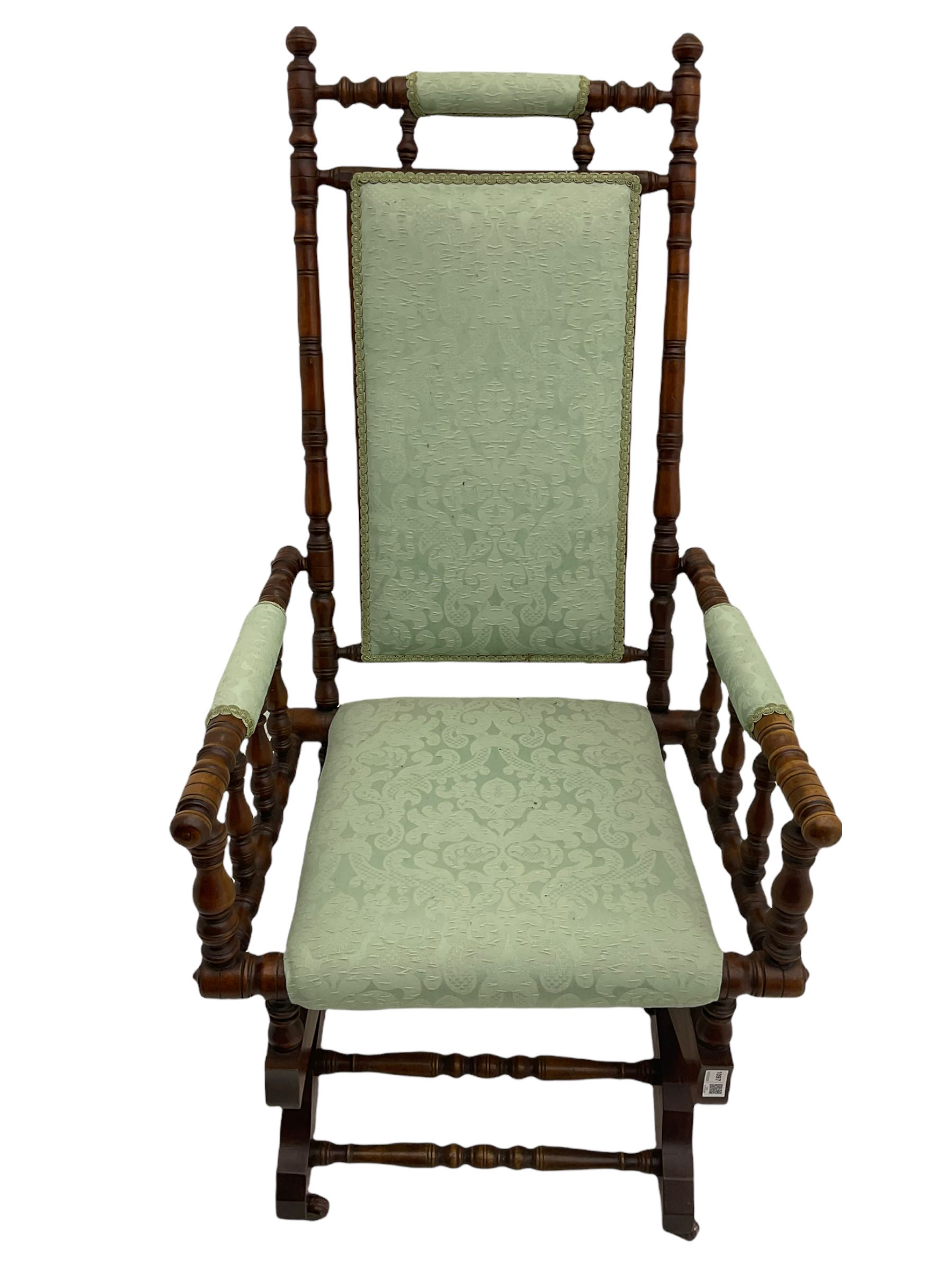 Early 20th century walnut framed American rocking chair, upholstered seat, back and arms
