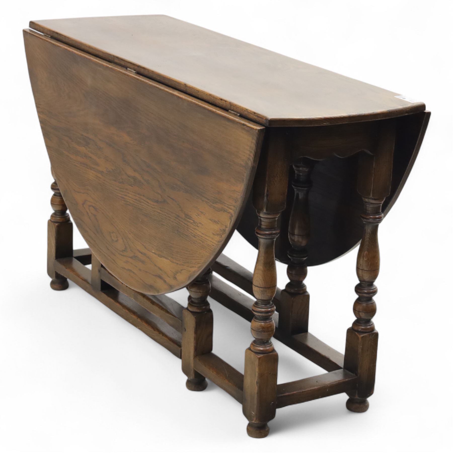 17th century design oak gateleg dining table, oval drop-leaf top on baluster turned supports, twin swinging gate legs united by peripheral stretchers (Extends to 149cm)