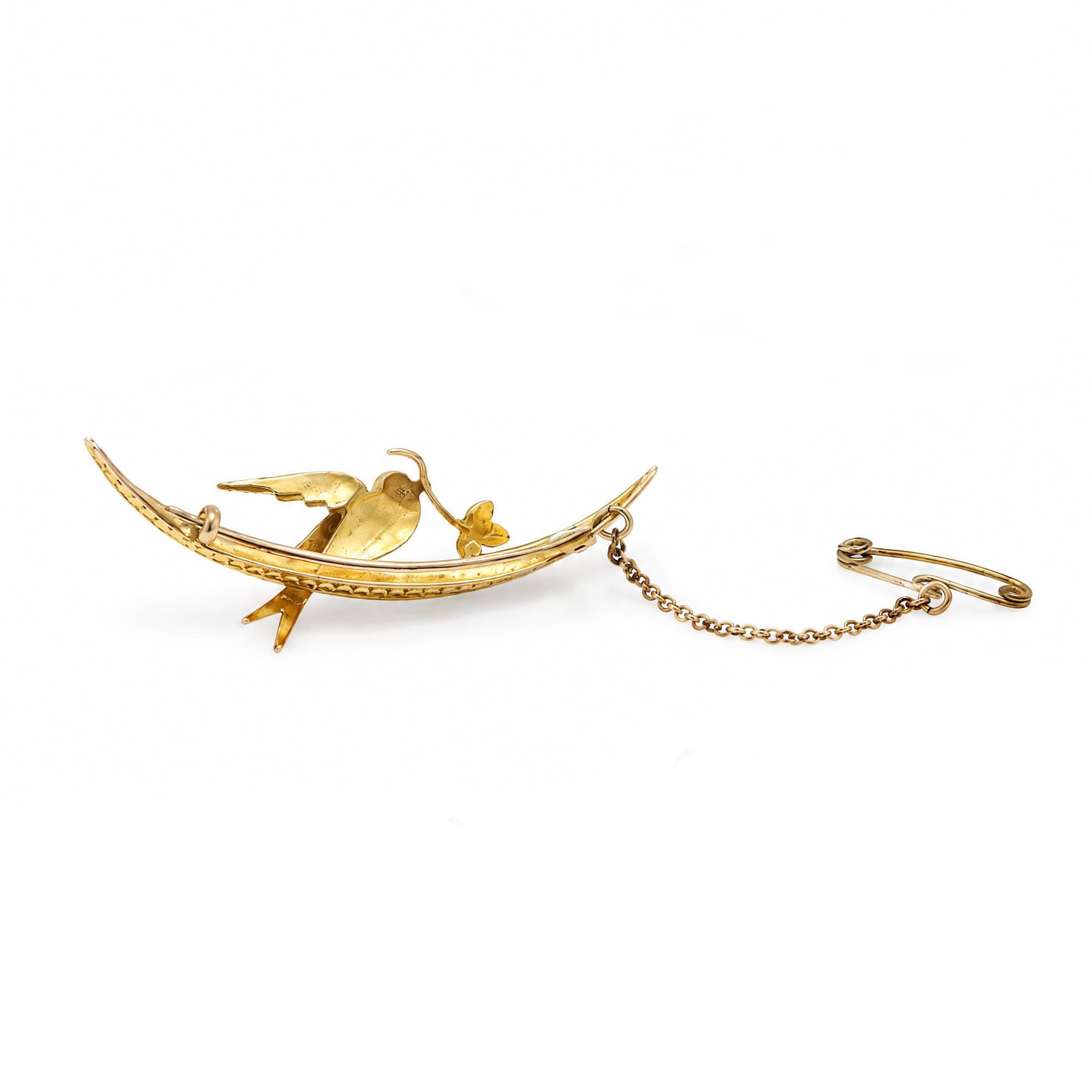Early 20th century 15ct gold pearl and diamond swallow brooch, the split pearl set bird perched on a crescent moon, holding a leaf set with rose cut diamonds