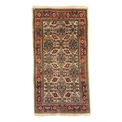 Persian-style wool rug, cream field with floral and geometric motifs, wide floral border (74cm x 142cm); Persian wool rug, beige field with dense floral patterns, narrow floral border (70cm x 144cm); Tribal wool rug, red and navy with diamond motifs (96cm x 60cm); Persian pictorial wool rug, black field with vase, birds, and floral border (70cm x 73cm)