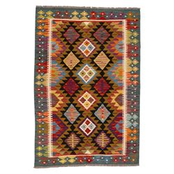 Afghan kilim rug, the field in earthy tones decorated with columns of repeating lozenges w...