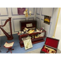 Scratch-built illuminated wooden doll's house type display of 'The Old Music Box' music shop, the hinged front opening to reveal a single room furnished with counter, piano, harp, figures, display cabinets, violin, saxophone and other musical instruments and accessories L51cm H28cm D29cm