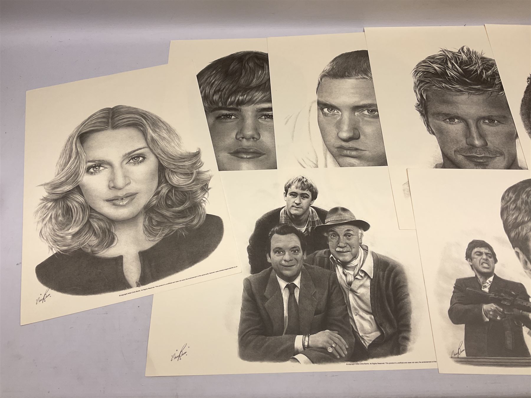 After Chris Burns, twenty-one unframed monochrome prints of pop, film and sports stars including The Beatles, John Lennon, Jimi Hendrix, Madonna, Marilyn Monroe, John Wayne, Bruce Lee, Audrey Hepburn, David Beckham, Manchester United etc. 29.5 x 42cm; some card mounted; and 1935 Silver Jubilee Daily Mail newspaper