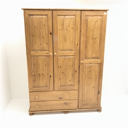 Pine triple combination wardrobe, three doors above two drawers on bun feet, W1325cm, H181cm, D51cm