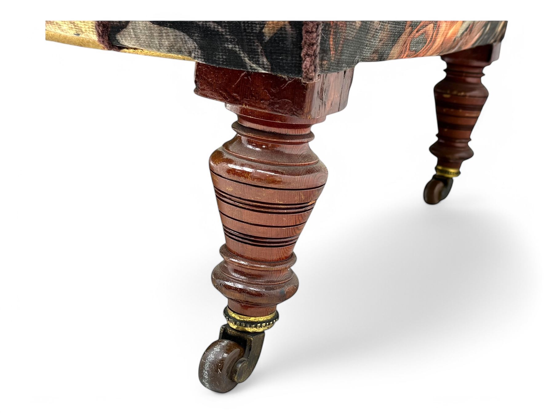 Victorian hardwood-framed chaise longue, serpentine back with rolled arm, upholstered in floral pattern fabric, on ring turned legs with ceramic castors 