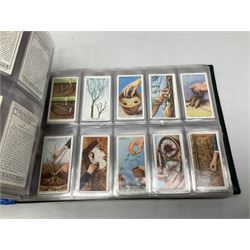 Three modern loose leaf albums containing a large quantity of cigarette and trade cards by Players, Wills, Lyons Maid, Churchman, Gallaher, Godfrey Phillips, Ty-Phoo, Senior Service, Ardath, Lyons Tea etc including Royalty, Mining, Railway, Cars, Sporting, Natural History, Military, Film & Radio Stars, General Knowledge etc