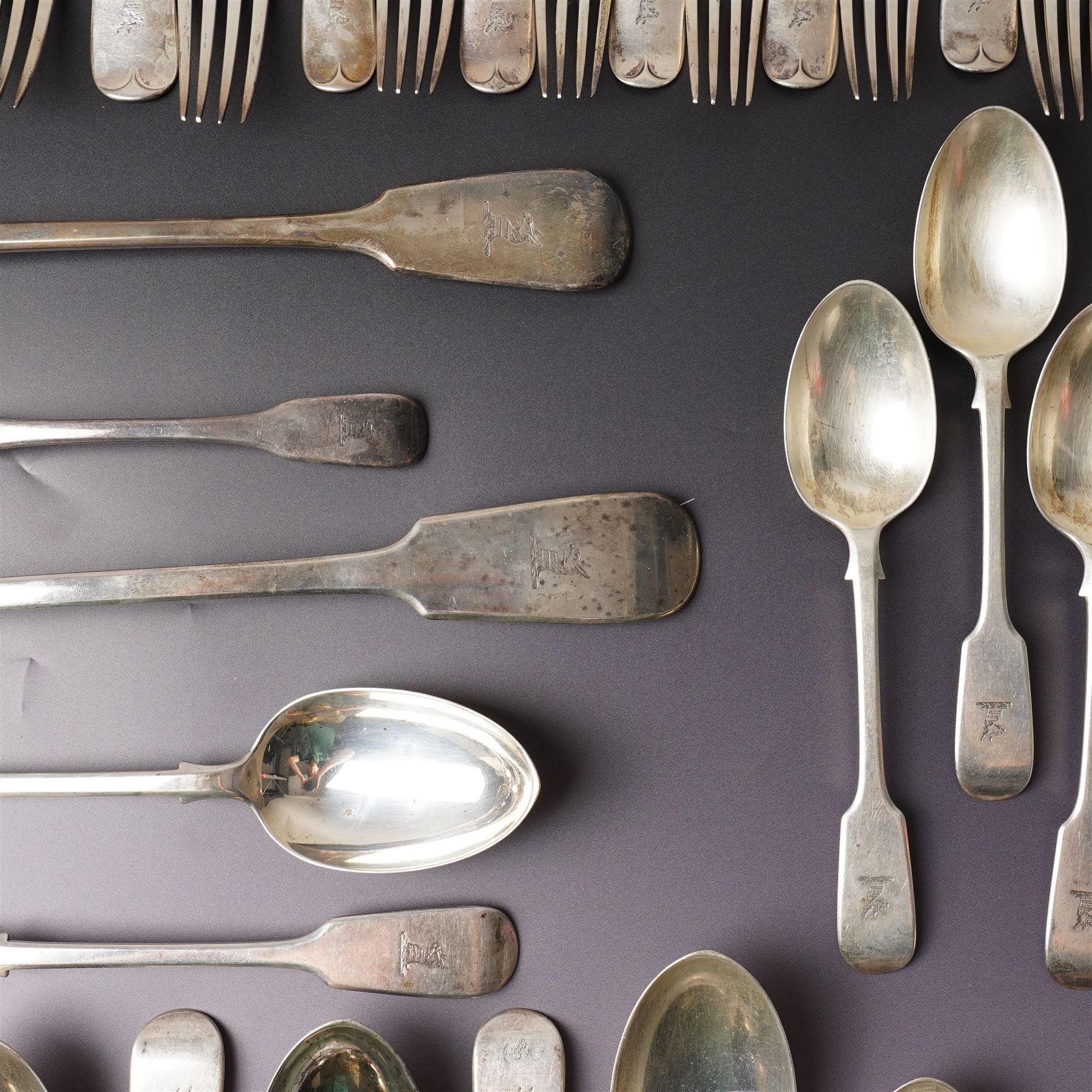 Silver Fiddle pattern canteen, composite, largely Victorian, comprising twelve table spoons, twelve table forks, twelve dessert spoons, eleven dessert forks, one soup ladle, one sauce ladle, and one serving spoon, each terminal engraved with The Everitt family Griffin crest, largely hallmarked Francis Higgins III, London 1892, soup and sauce ladle dated 1808 and 1828 

Provenance: From the collection of Andrew Chichester Everitt.



