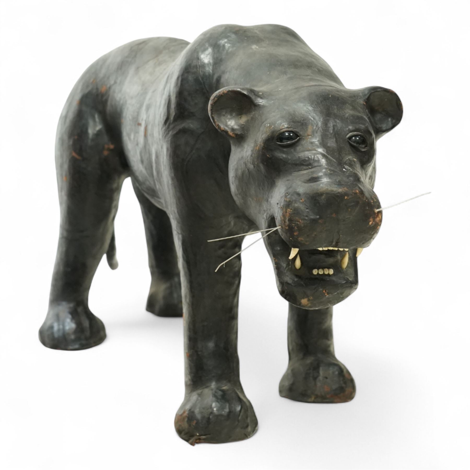 Early 20th century leather-covered decorative model of a Panther in a naturalistic stance, prowling forward with arched back, lowered head, and extended tail, open jaws revealing teeth and fangs with nylon whiskers