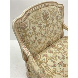 French style armchair, shaped and moulded frame in cream finish, upholstered in a cream ground fabric with classical urn and floral pattern, serpentine seat, cabriole supports
