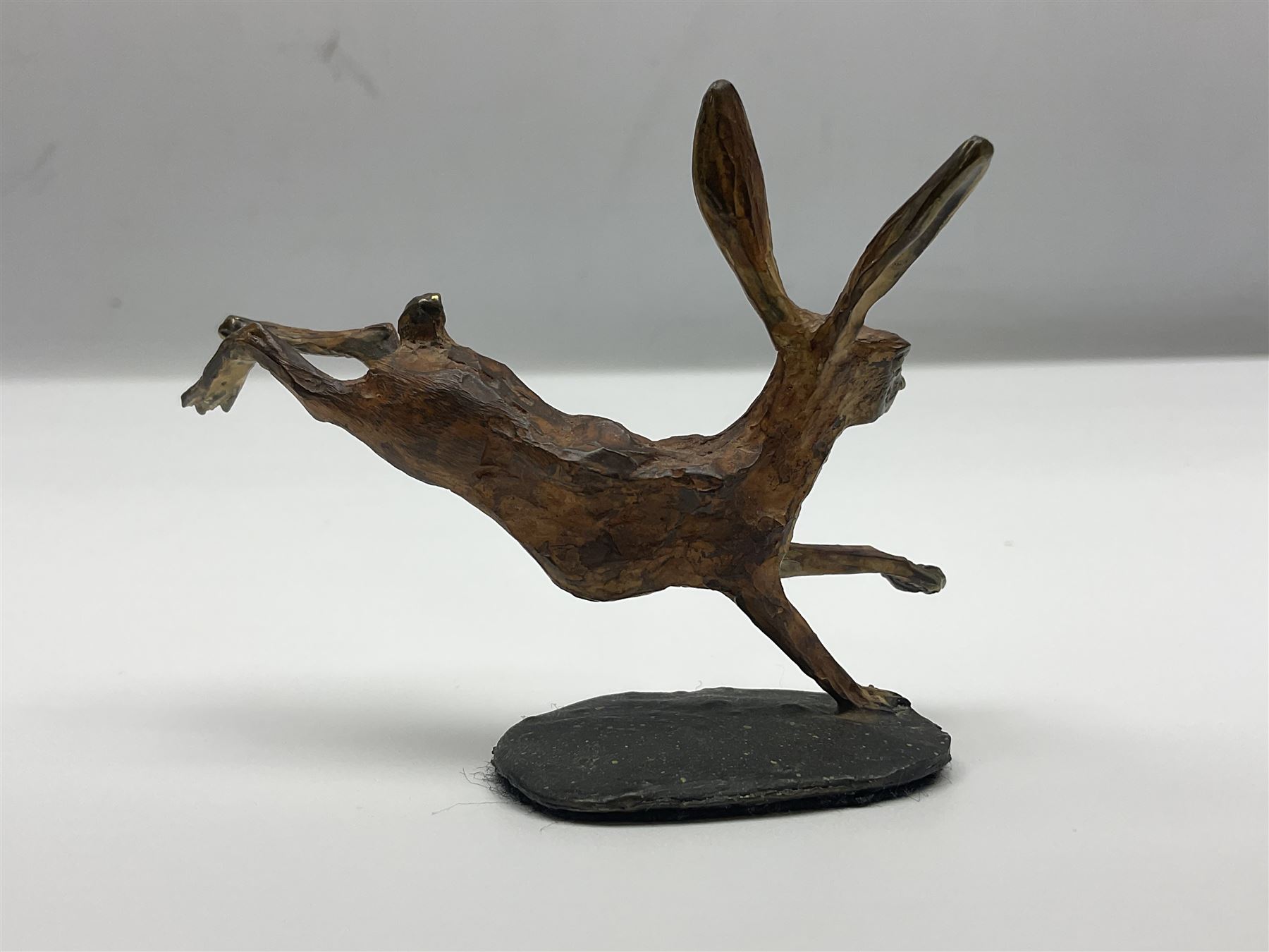 Michael Storey (British 1948-): 'Running Hare', bronze of a hare, H7cm, L10cm 