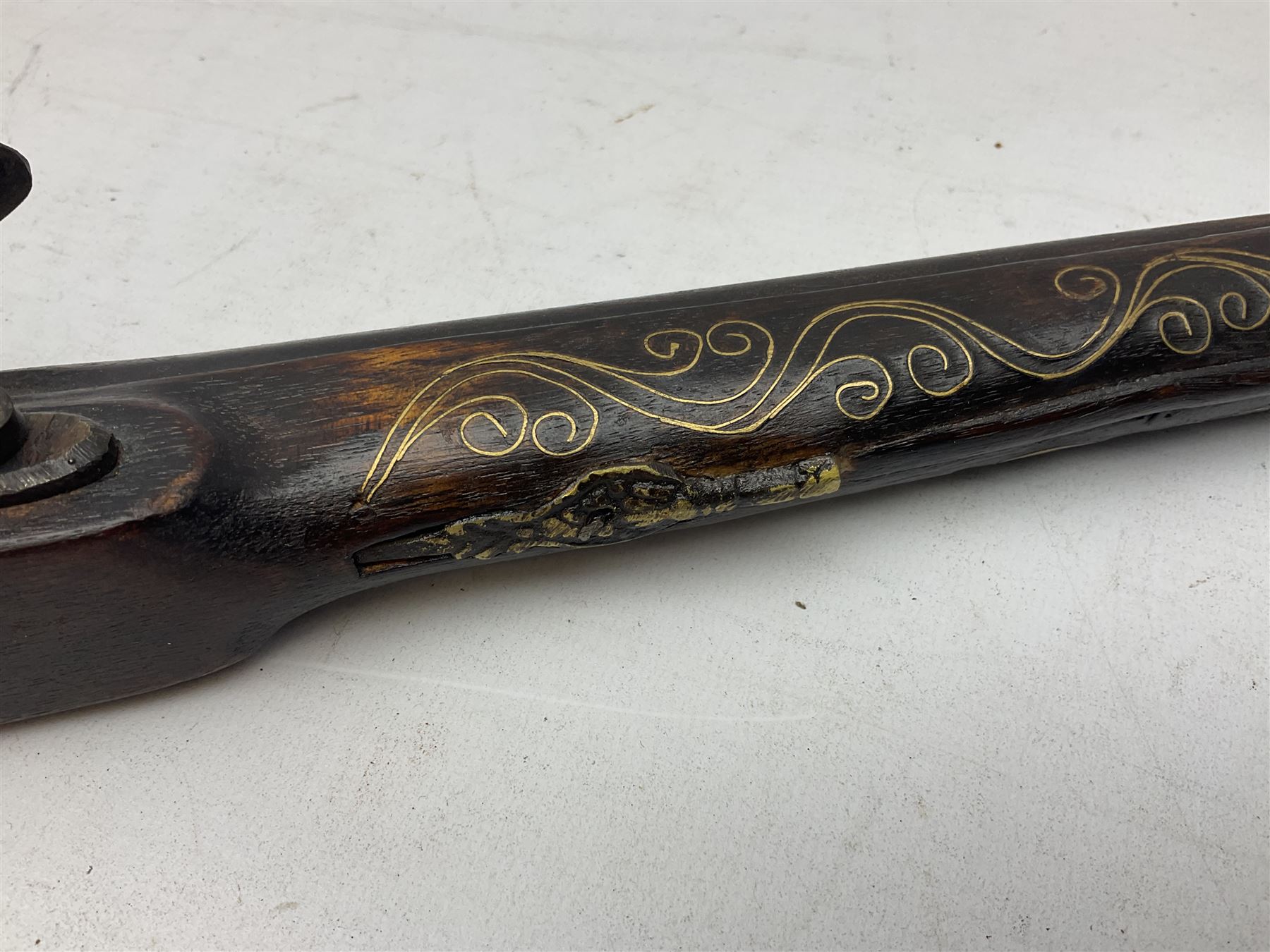 Reproduction flintlock pistol, the full walnut stock with brass filigree inlay and mounts and skull crusher butt L46cm; no visible proof marks FIREARMS CERTIFICATE REQUIRED OR RFD
