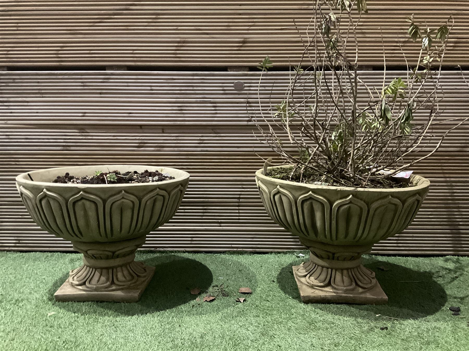 Pair of large decorated cast stone planters on plinths  - THIS LOT IS TO BE COLLECTED BY APPOINTMENT FROM DUGGLEBY STORAGE, GREAT HILL, EASTFIELD, SCARBOROUGH, YO11 3TX