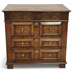 John Nethercott & Co - late 20th century hand-made oak 17th-century design chest of drawers, rectangular pegged and planked top above scrollwork carved frieze concealing two drawers, over three drawers, all with raised rectangular moulding and drop handles, raised on stile feet, the back with dated label for John Nethercott & Co