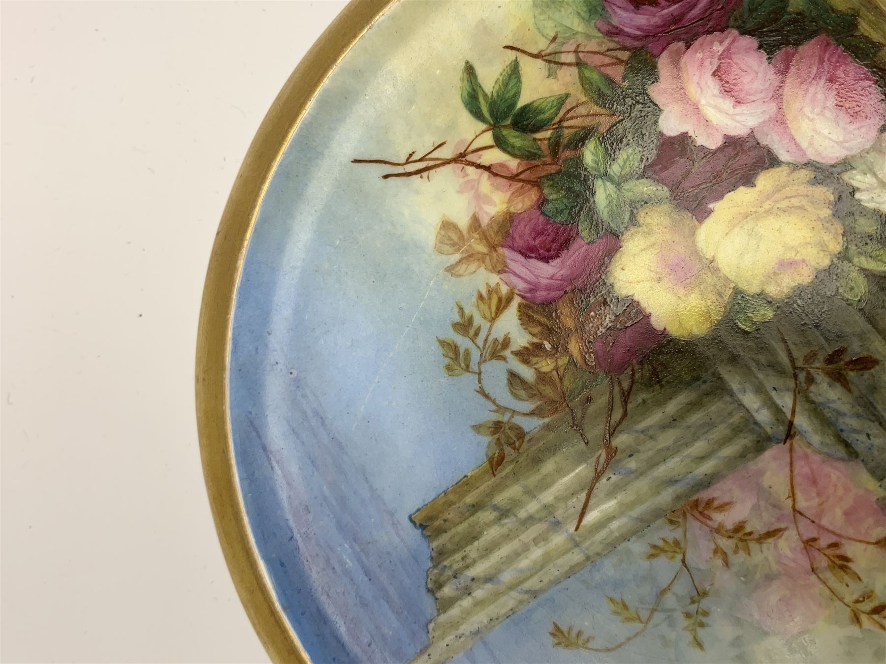 19th century porcelain stand, of circular form, in the Derby style, hand painted with a ruinous column and roses against a landscape background, within a gilt border, D7cm