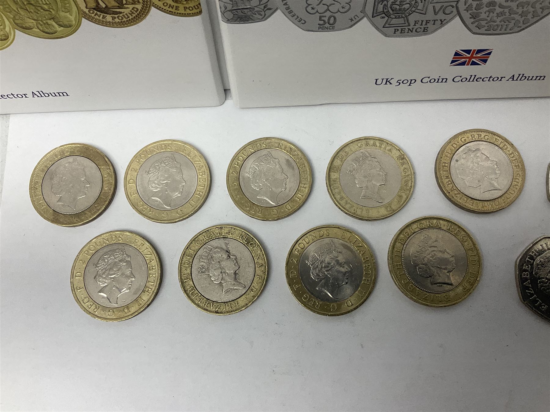 The Royal Mint United Kingdom mostly commemorative two pound, old round one pound and fifty pence coins, overall face value approximately 110 GBP, housed in three 'Coin Hunt' folders and loose