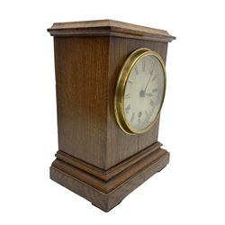 German - late 19th century oak cased 8-day timepiece mantle clock , with a flat top, moulded  base raised on block feet, painted dial with Roman numerals and spade hands within a glazed brass bezel, spring driven movement with pendulum and key. 