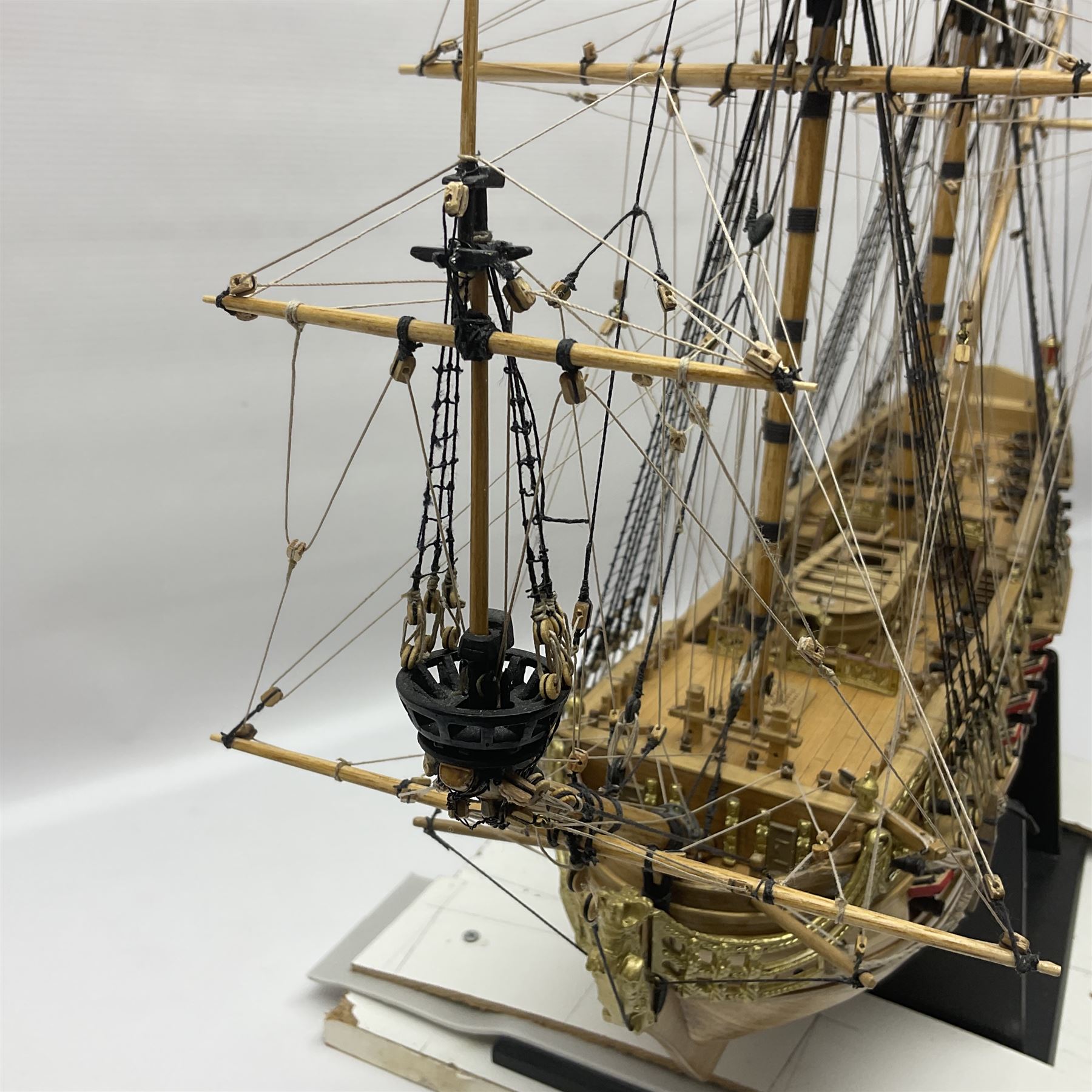 Wooden kit built model of HMS Neptune, 1:90 scale, with detailed rigging to three masts and a row of cannons to either side, upon ebonised wooden base, including stand H71cm