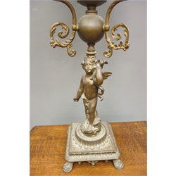  Victorian style cast metal figural oil lamp, three scrolling supports, floral decorated opaque glass shade with drops and clear glass chimney, H96cm overall  