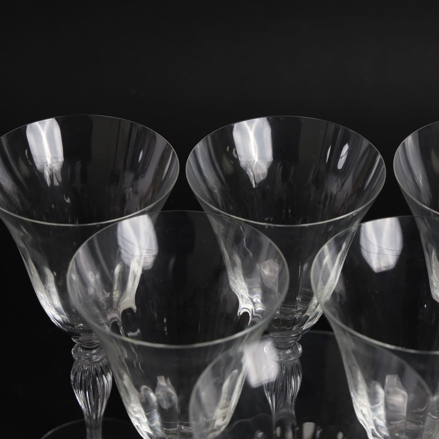 Set of six Murano clear glass wine glasses, each with part moulded fluted flared bowl, upon a knopped and fluted baluster stem and spreading circular foot, with etched marks beneath, H19.5cm
