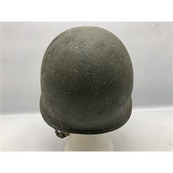 American first type paratrooper helmet with post-WW2 strap and D-rings and later 1944 liner bearing Firestone Tyre and Rubber Company mark; green textured finish