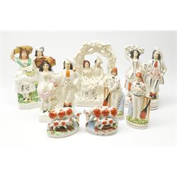 A group of various flatback figures, to include two 19th century Staffordshire flatback figures, one an arbour group, together with other later Staffordshire style examples, including a pair modelled as cow and half. (7). 

