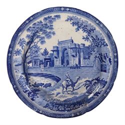 Early 19th Century Spode Caramanian series serving dish, printed in blue and white with the Triumphal Arch at Tripoli in Barbary, reserved within a running border of Indian sporting animals, together with Rogers Camel pattern platter and plate, Adams Lions plate and Davenport platter, largest platter L43cm 