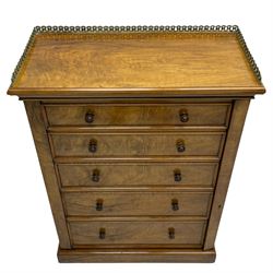 Johnstone Jeanes & Co - Late 19th century walnut Wellington chest, rectangular top with raised cast brass gallery of interlocking foliate design, over five graduating drawers with moulded facias and turned roundel handles, fitted with hinged lock to the right, on skirted base