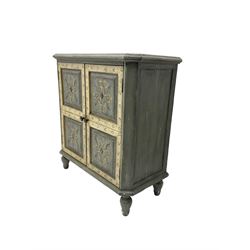 Painted side cabinet, fitted with two cupboard doors with panelled fronts enclosing shelf, painted with tulip and scrolling foliate design, chamfered uprights raised on turned feet, in white and grey-blue finish