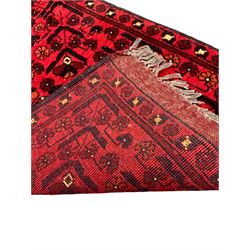 Small Persian magenta ground rug, central Mirab with flanking columns enclosing stylised urn motif with trailing foliage, the triple band border with plant motifs (86cm x 46cm); Persian red ground rug, two central floral medallions with extending flower heads, floral decorated border (106cm x 53cm) (2)