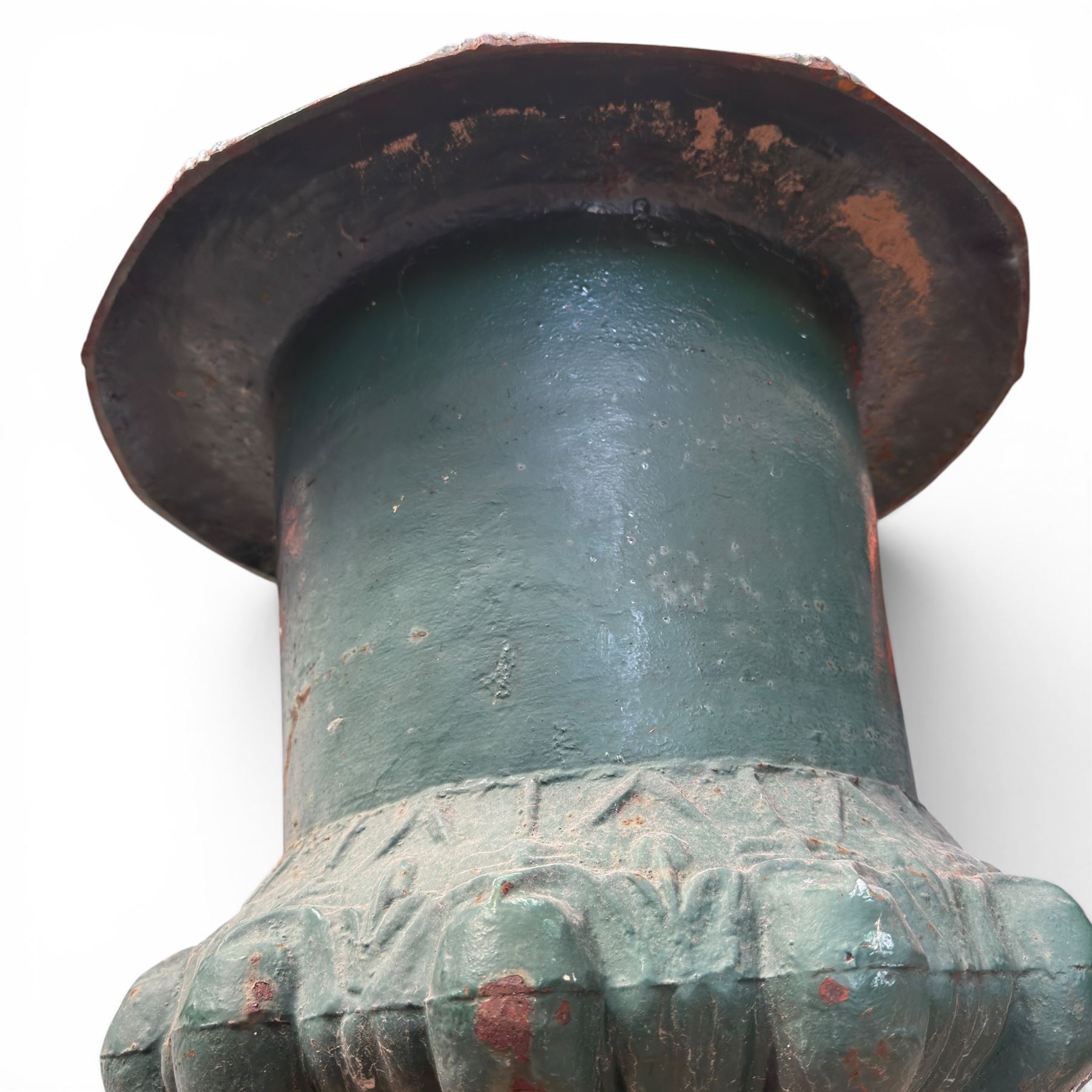 Pair of Victorian cast iron campana garden urns, the flared rim with repeating stylised anthemion motifs with scrollwork, over a deep gadrooned and Aesthetic moulded underbelly, fluted and foliate lower bowls on square pedestal bases, in antique green-painted finish