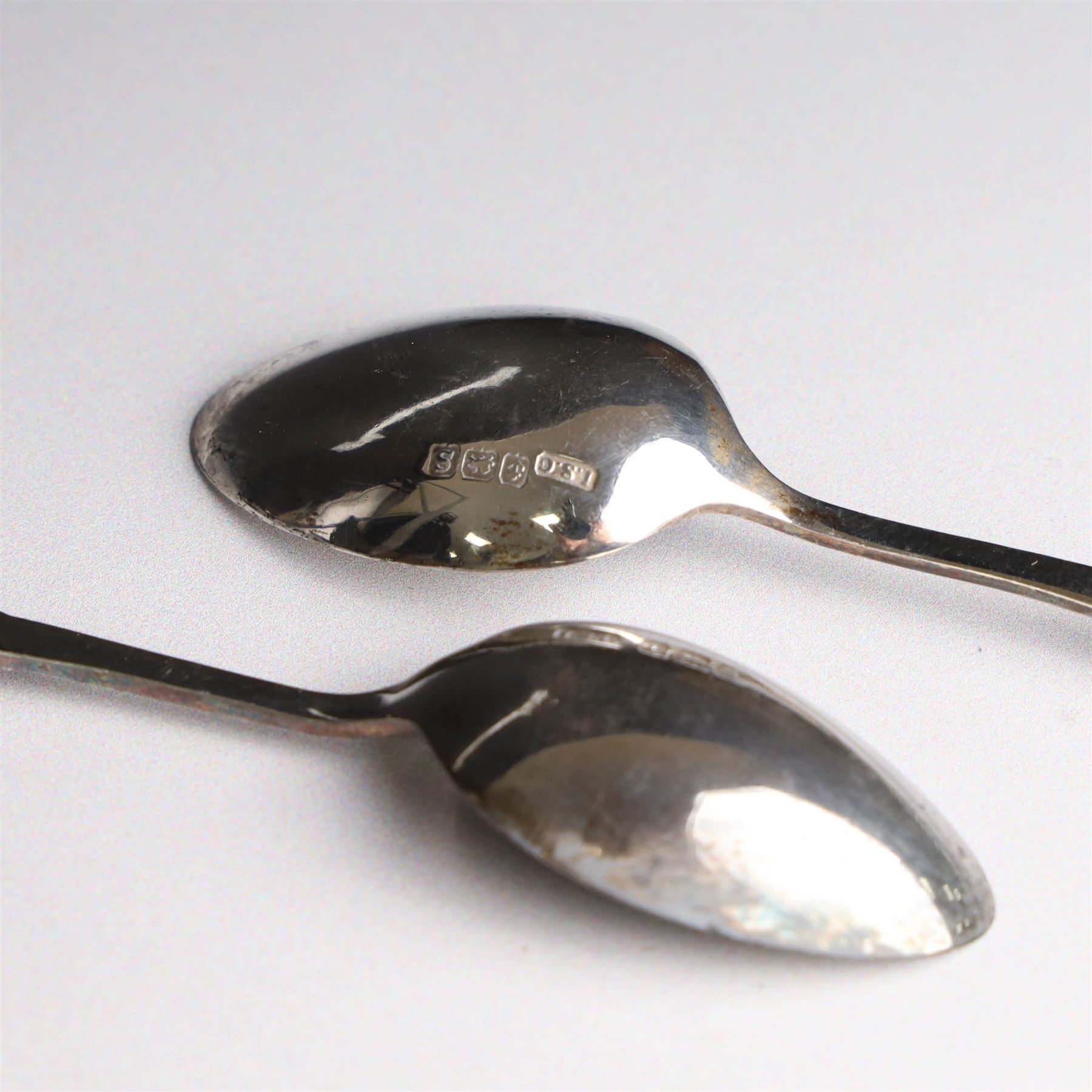 Set of six silver teaspoons and sugar tongs, with embossed foliate decoration, hallmarked I S Greenberg & Co, Birmingham probably 1917