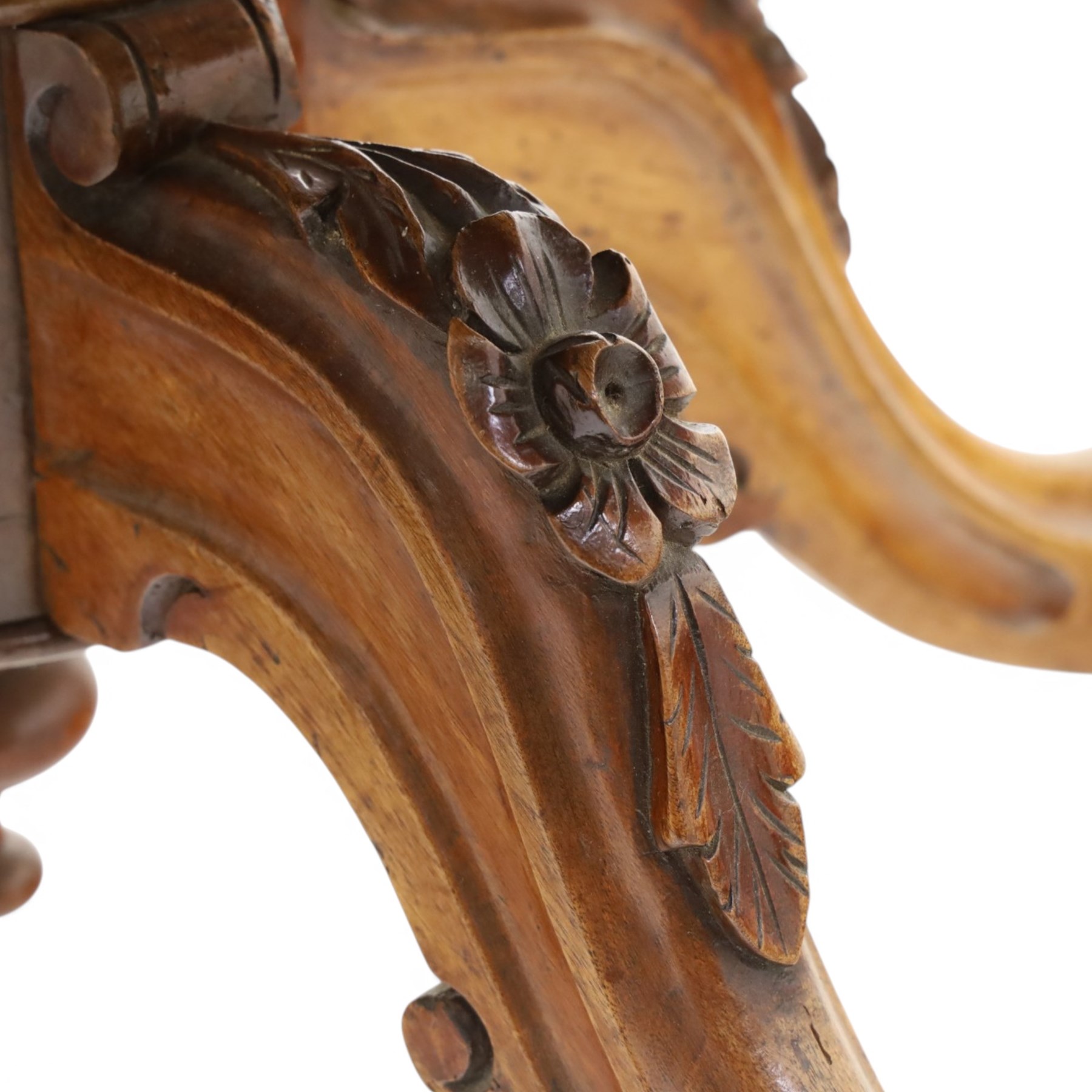 Victorian figured and burr walnut loo table, oval book-matched veneer top with moulded edge, over a turned octagonal pedestal terminating to four splayed supports with flowerhead carved knees and scroll feet with castors