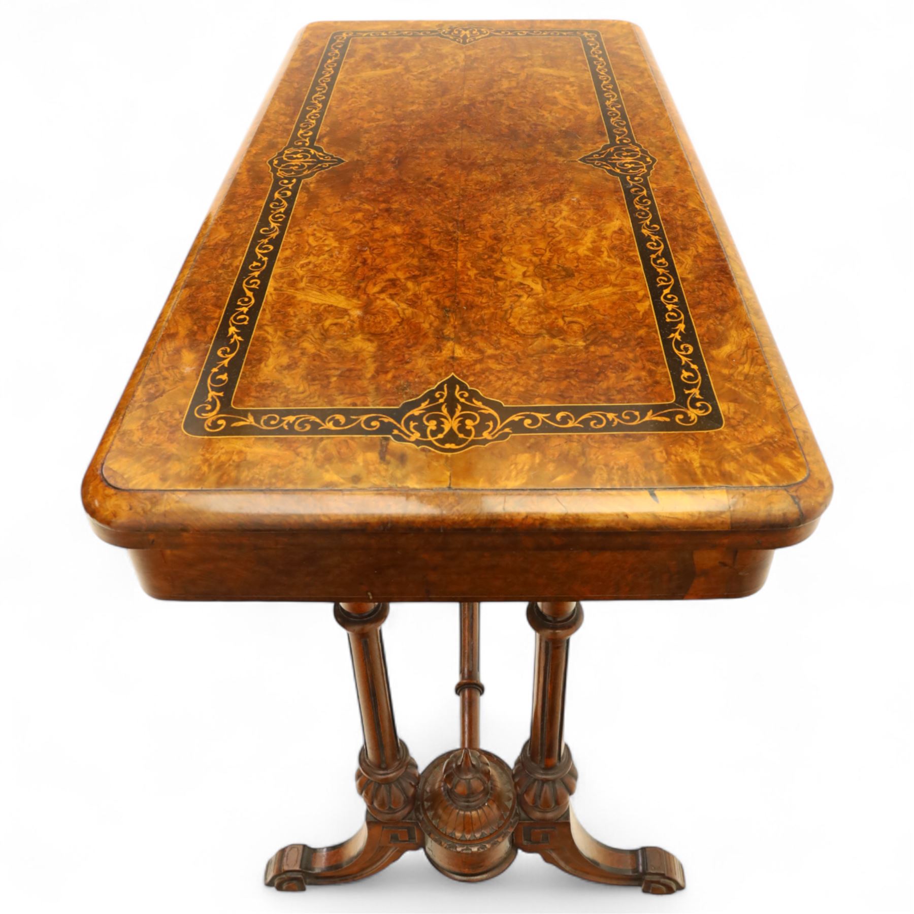 Victorian walnut and inlaid games table, rectangular fold-over top with figured walnut veneers and foliate inlay, swivel and fold over to reveal a green baize lined playing surface, on twin supports united by a stretcher, raised on scroll carved feet with castors (extended 96cm x 92cm)
