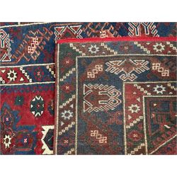 Persian red and blue ground rug, the field decorated with three stylised star medallions, surrounded by triple band border with repeating design