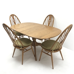 Ercol Chester elm extending pedestal dining table, turned column on four shaped supports (W148cm, H73cm, D90cm) and set four elm swan high back dining chairs (W48cm) and a Windsor swept back chair