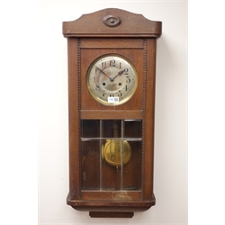  20th century oak wall clock with silvered Arabic dial and bevelled panel glazed door, twin train movement striking the half hours on a coil, H77cm  