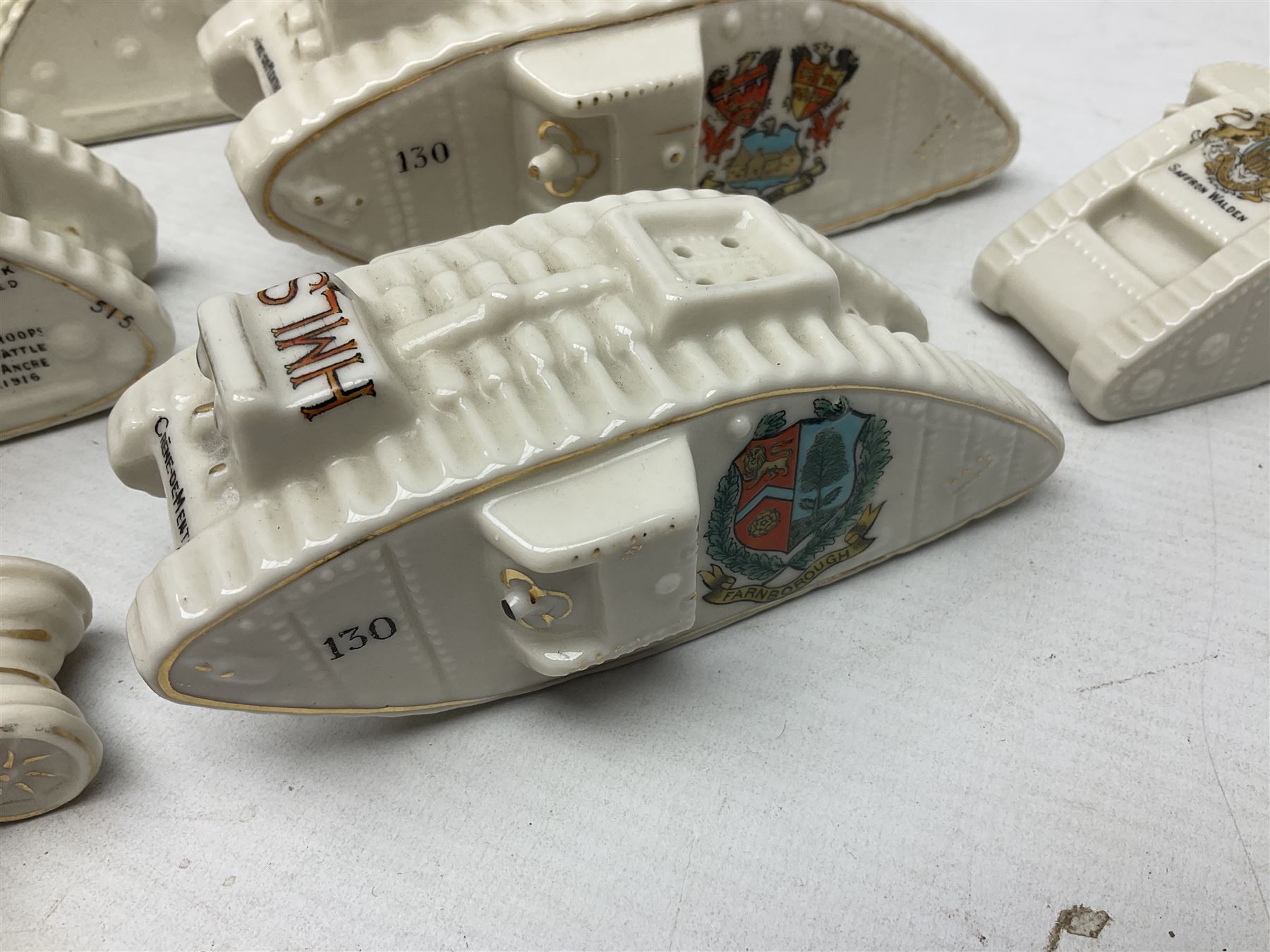 Twelve crested china models of WW1 tanks by Grafton, Arcadian and Carlton china etc with crests from Caistor Lincs, Saffron Walden, Paignton, Evesham etc  , together with a crested china model of the R.M.S Lusitania with New Brighton crest and a two-handled vase for 'The Forts Boxhill' (14)