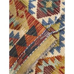 Chobi Kilim runner, cream ground with a multicoloured lattice of repeating diamond motifs, framed by a geometric border, finished with braided corner tassels