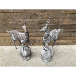 Pair of cast iron garden Stag figures or gate finials, raised on spherical ribbed base 