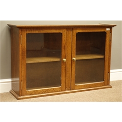  Early 20th century oak bookcase enclosed by two glazed doors, W100cm, H62cm, D26  