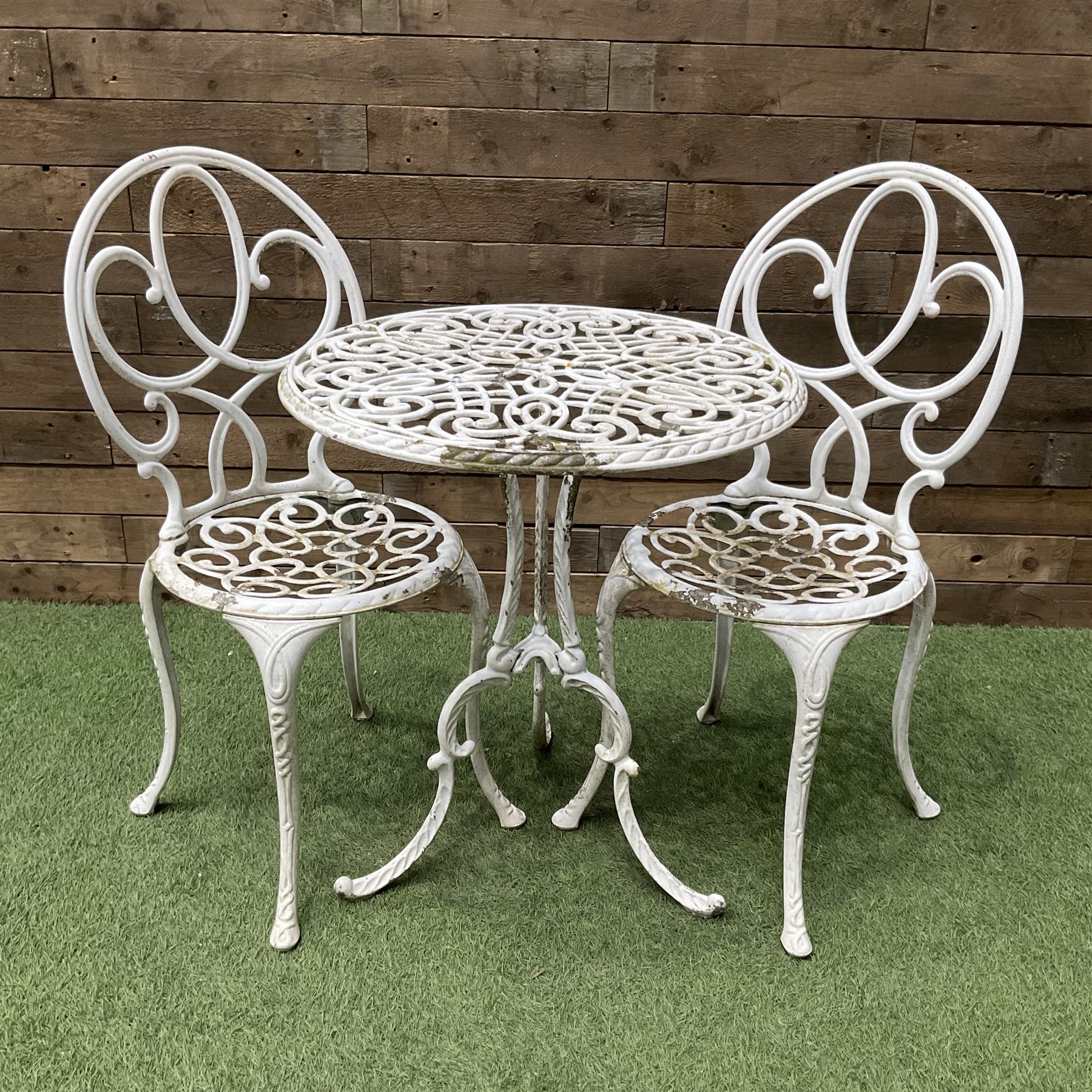 Cast aluminium garden table and two chairs painted in white - THIS LOT IS TO BE COLLECTED BY APPOINTMENT FROM DUGGLEBY STORAGE, GREAT HILL, EASTFIELD, SCARBOROUGH, YO11 3TX