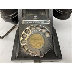 Two black bakelite rotary telephones, with chrome dialling wheels, to include example with 'Call Exchange' plaque to front