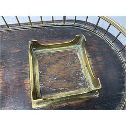 Early 20th century oak desk stand, of oval form with brass gallery and twin brass square sections, holding two removable clear glass inkwells with brass hinged covers, the whole upon four brass compressed bun feet, L30cm