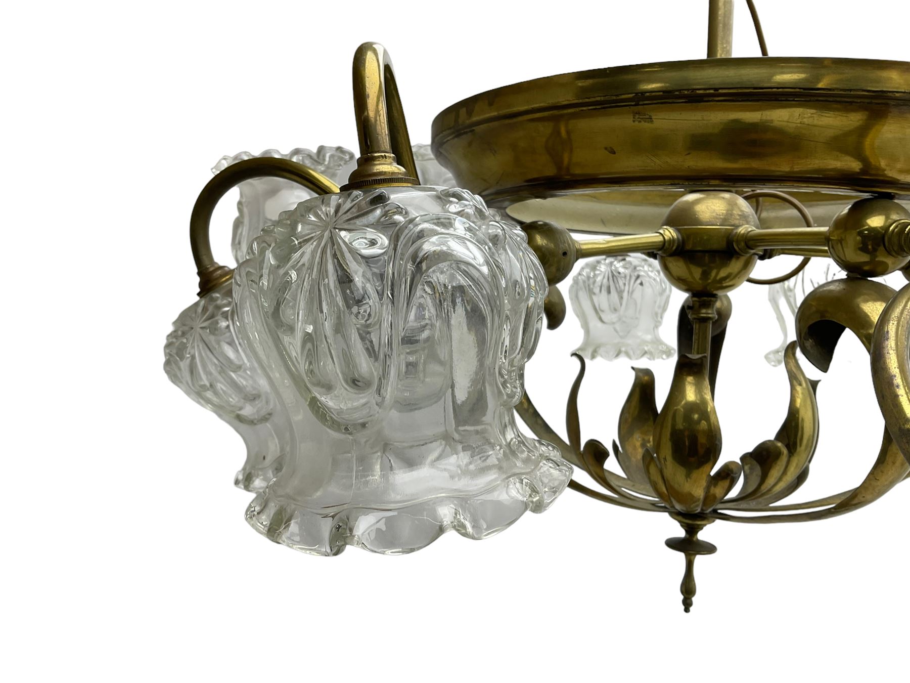 Mid-20th century brass lightolier or light fitting, the scrolling foliate branches connected with a central ring, terminating in ten tulip shaped cut glass sades, pointed terminal beneath