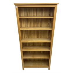 Contemporary light oak open bookcase, fitted with five adjustable shelves