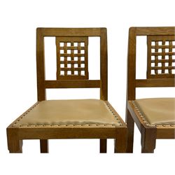 'Rabbitman' set of eight oak dining chairs, pierced lattice backs, upholstered seats with studwork band, octagonal front supports joined by stretchers, carved with rabbit signature, two carvers and six side chairs, by Peter Heap of Wetwang